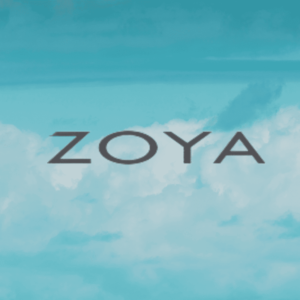 Text "ZOYA" in bold against a blue sky with clouds.