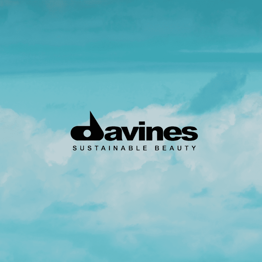 Logo of Davines with the tagline "Sustainable Beauty" set against a cloudy blue sky background.