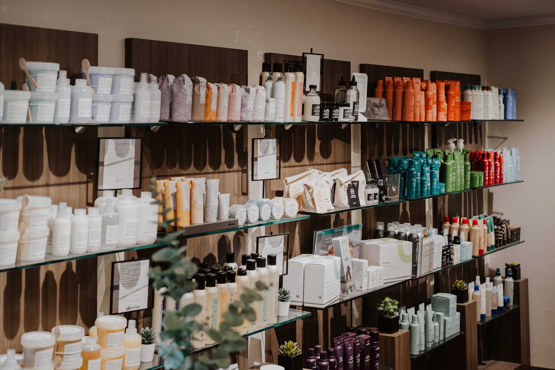 Shelves filled with various hair care products in a well-organized beauty supply store.